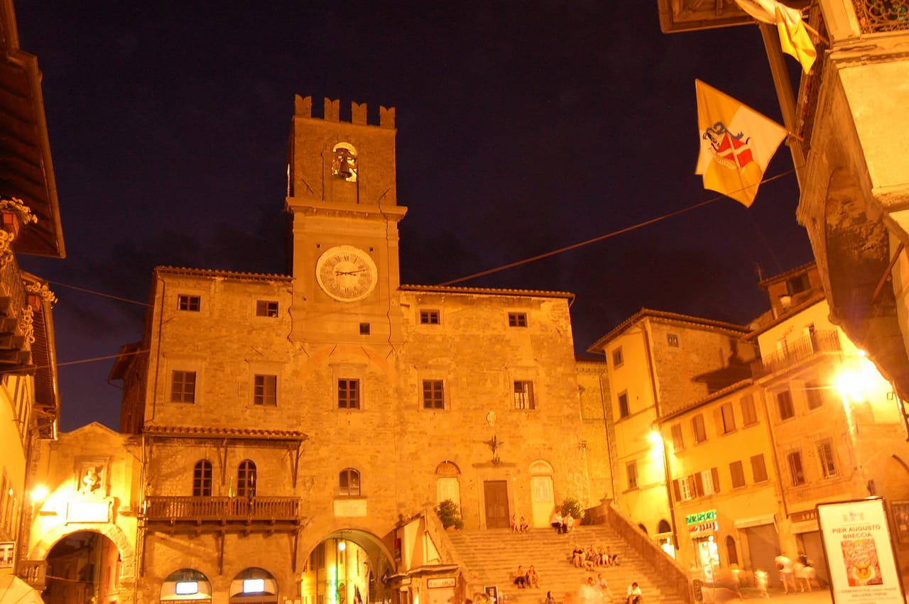 Piazza della Repubblica in Cortona at night, with the Palazzo Comunale and the Christmas lights switched on